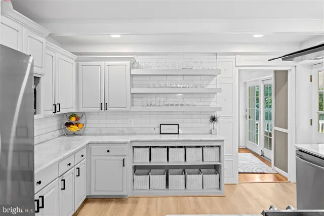 a kitchen with stainless steel appliances a sink and a refrigerator