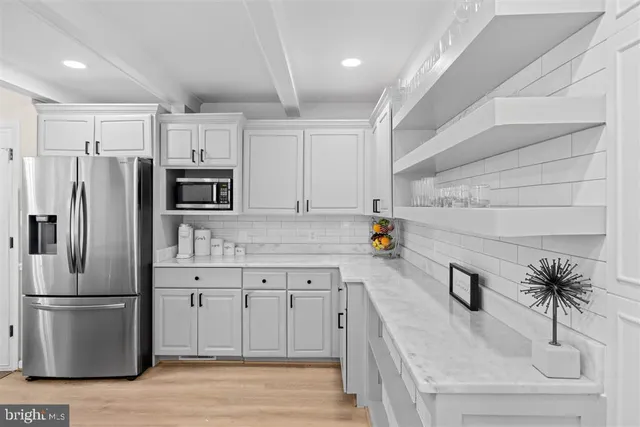 a kitchen with stainless steel appliances a refrigerator sink and cabinets