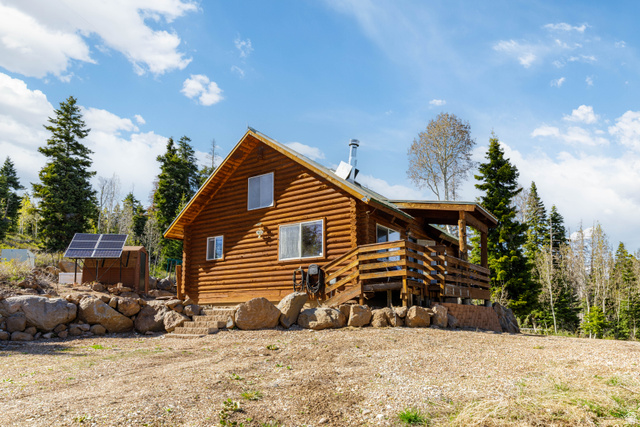706 Tranquility Drive Springdale, UT 84767 - Photo 3 of 55 Classic Log Cabin Exterior: Authentic log construction nestled perfectly into the high-altitude mountain landscape.