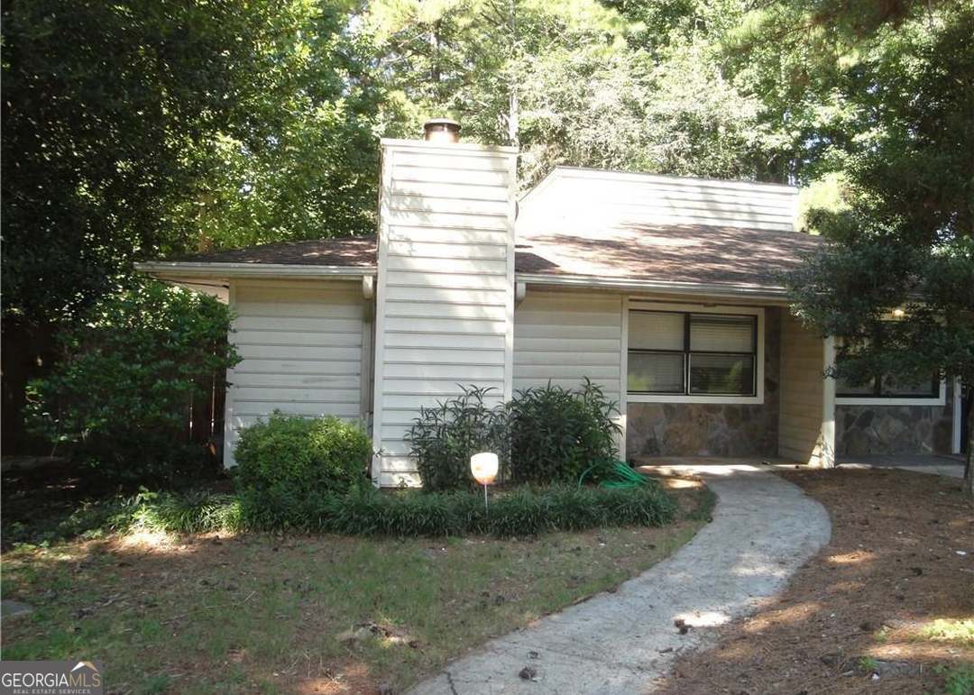 a house that has a tree in front of it