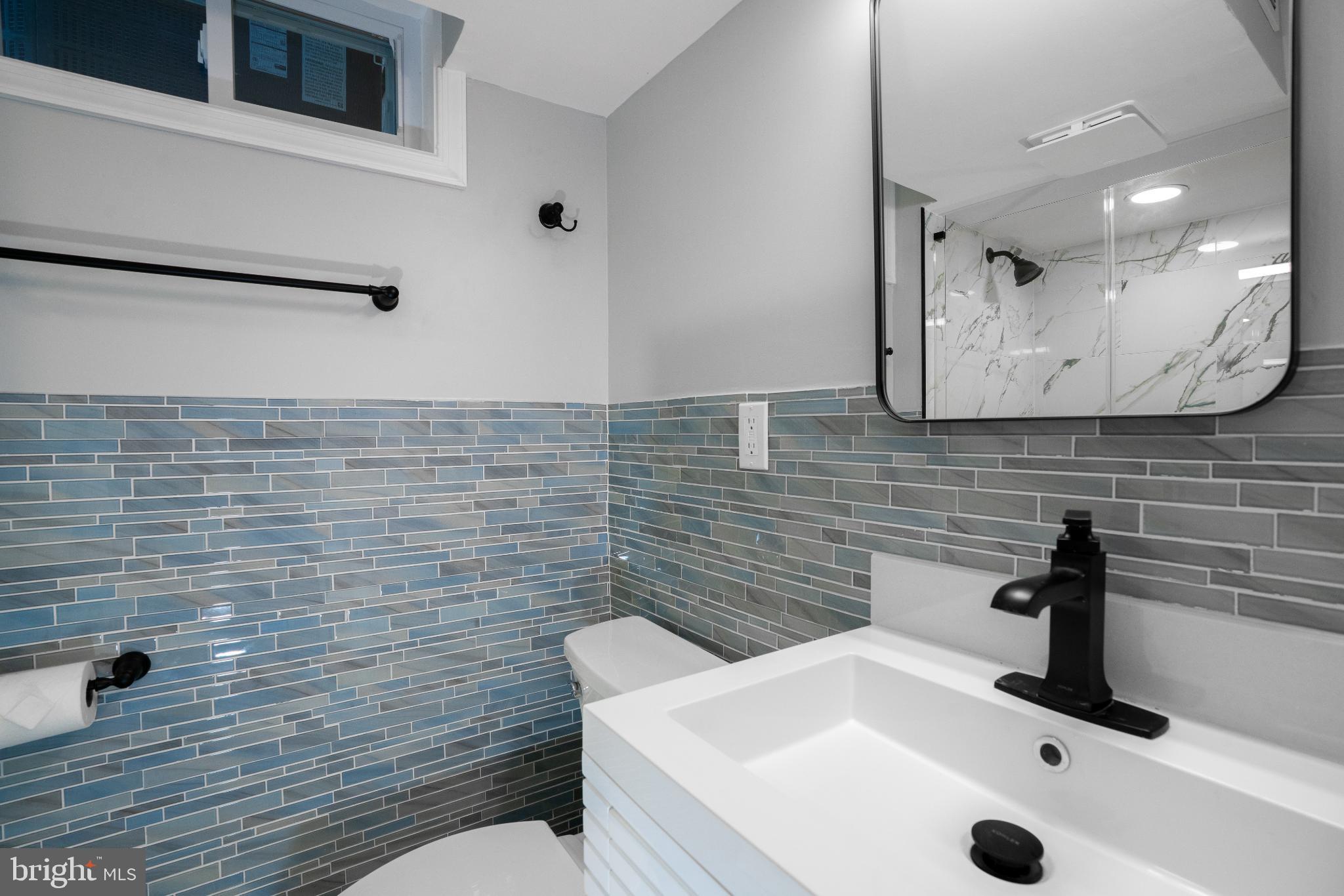 2652 Cory Terrace Silver Spring, MD 20902 - Photo 13 of 33 a bathroom with a sink a toilet and mirror