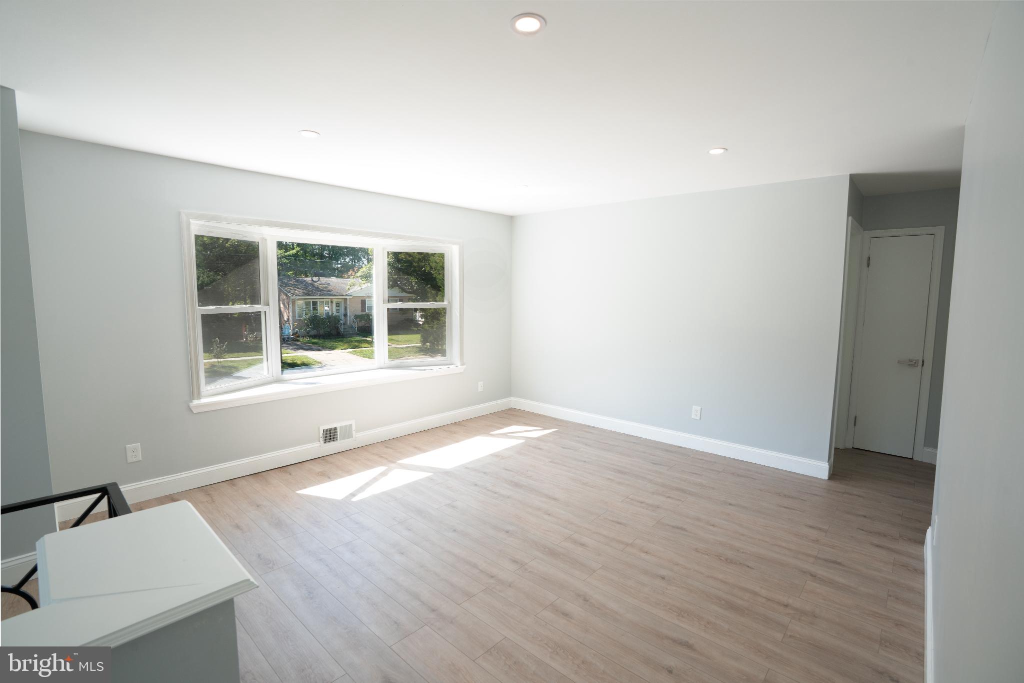 2652 Cory Terrace Silver Spring, MD 20902 - Photo 4 of 33 a view of an empty room with wooden floor and a window
