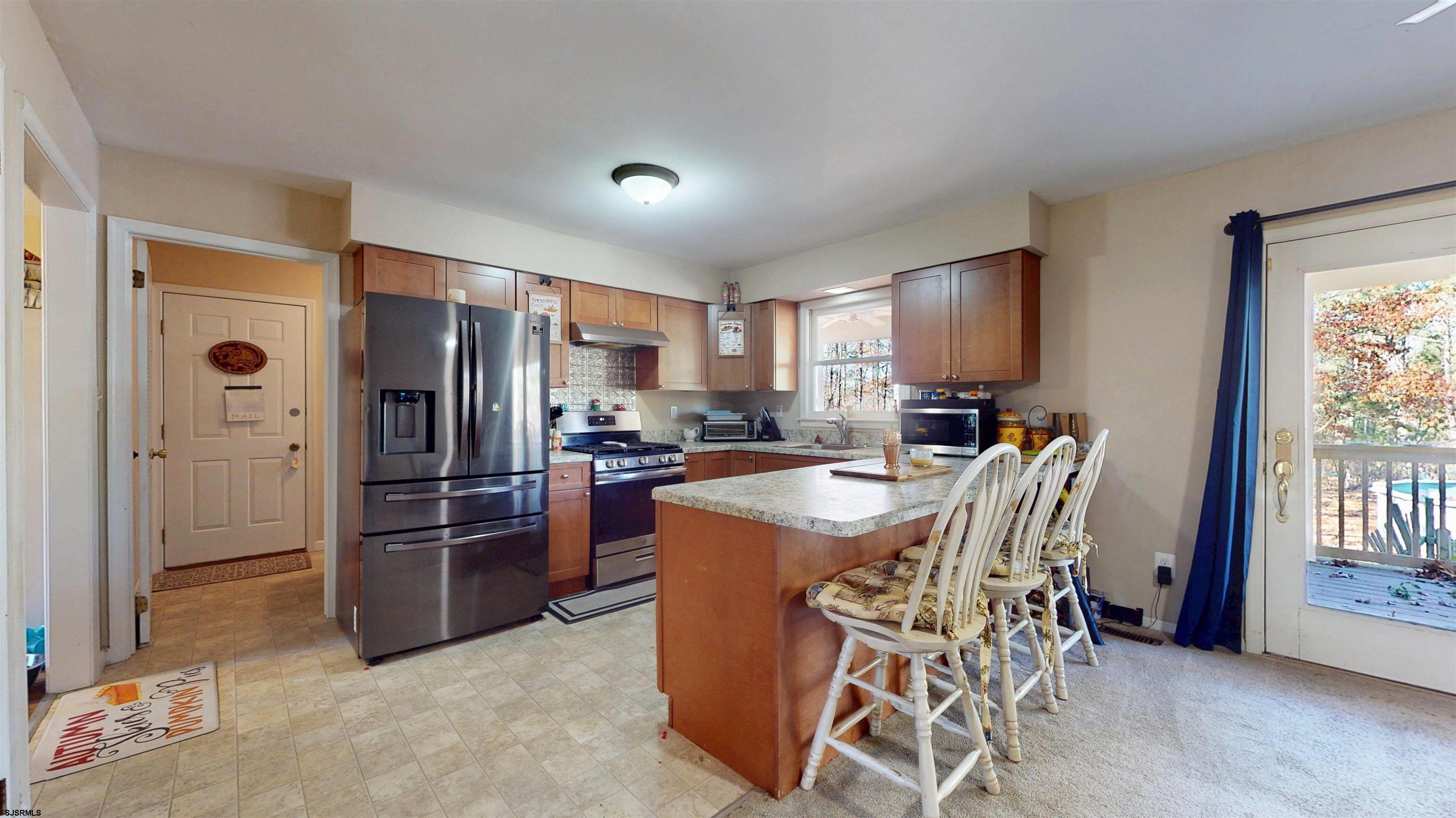 28 Luke Court Seaville, NJ 08230 - Photo 11 of 39 a kitchen with stainless steel appliances a refrigerator a stove a sink a table and chairs