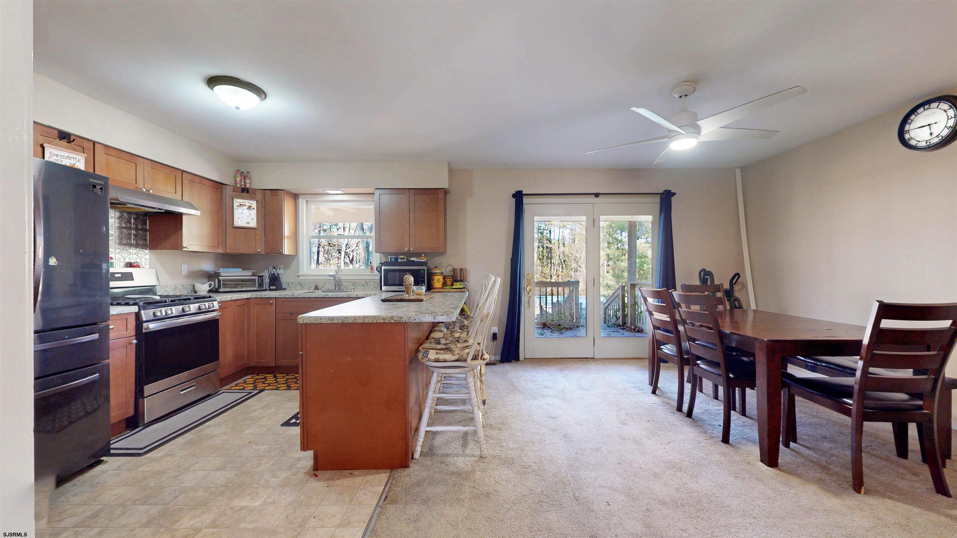 28 Luke Court Seaville, NJ 08230 - Photo 12 of 39 a large kitchen with kitchen island a dining table and chairs