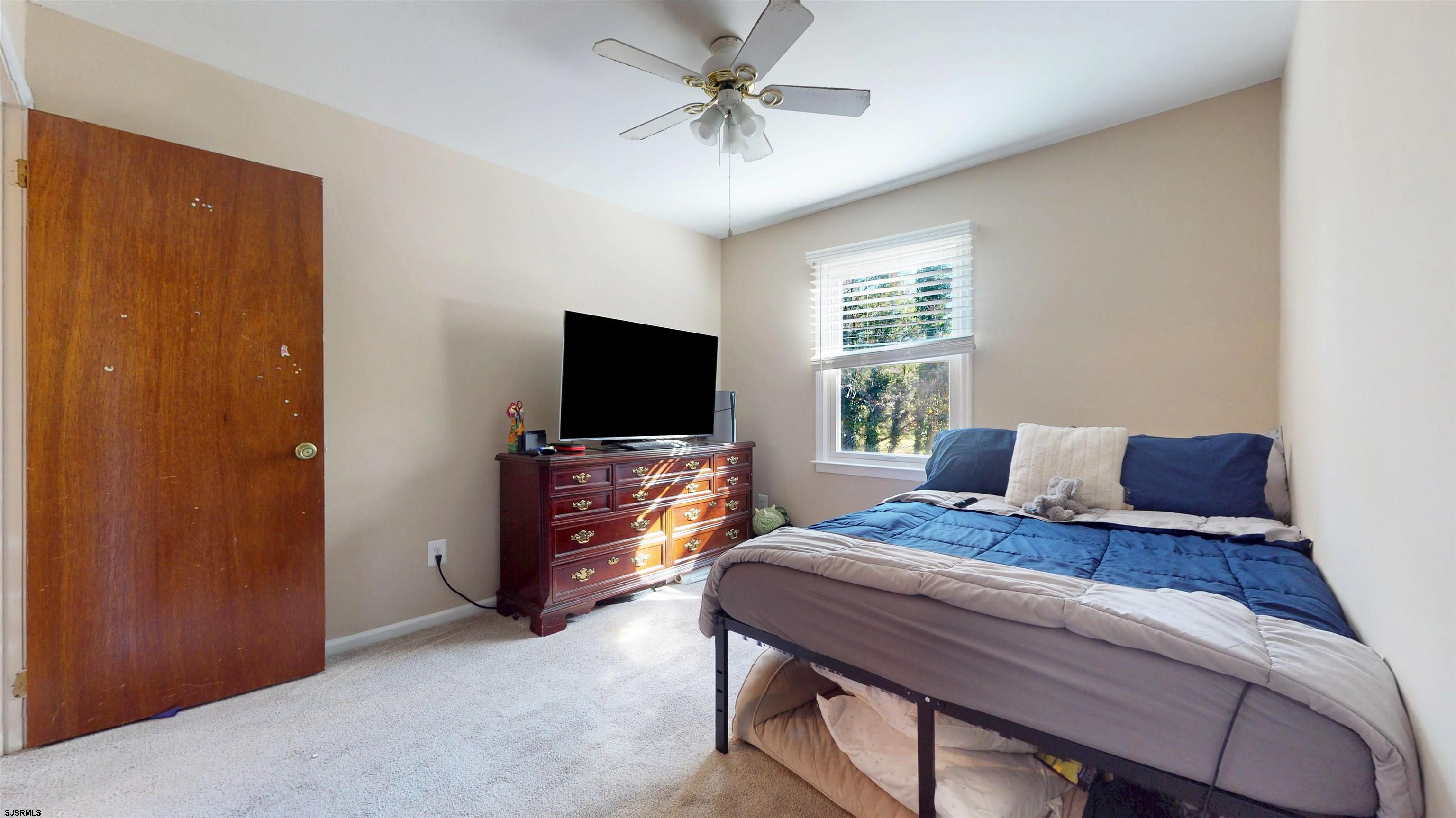 28 Luke Court Seaville, NJ 08230 - Photo 24 of 39 a bedroom with a bed and a flat screen tv