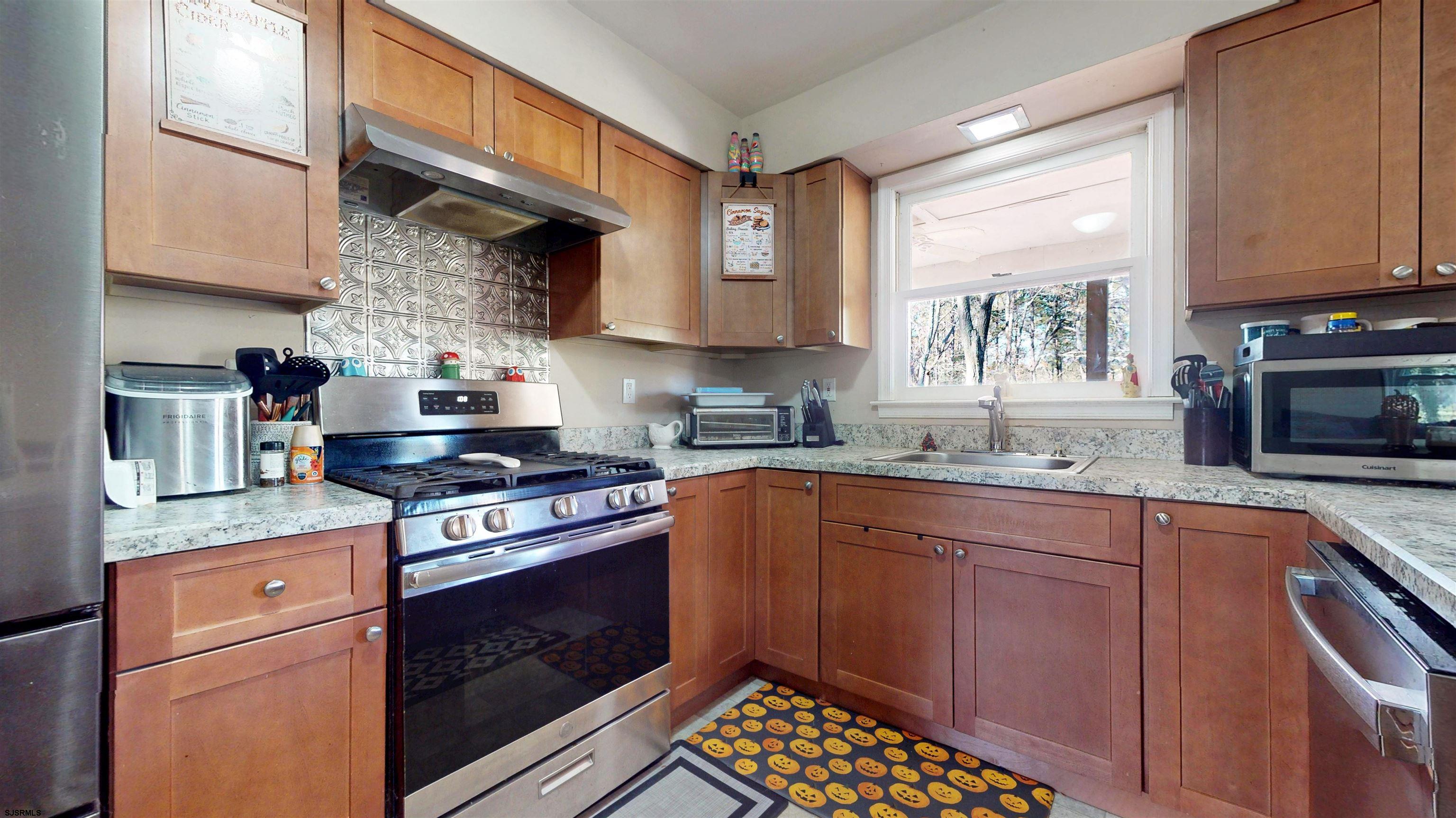 28 Luke Court Seaville, NJ 08230 - Photo 8 of 39 a kitchen with stainless steel appliances granite countertop a stove sink and cabinets
