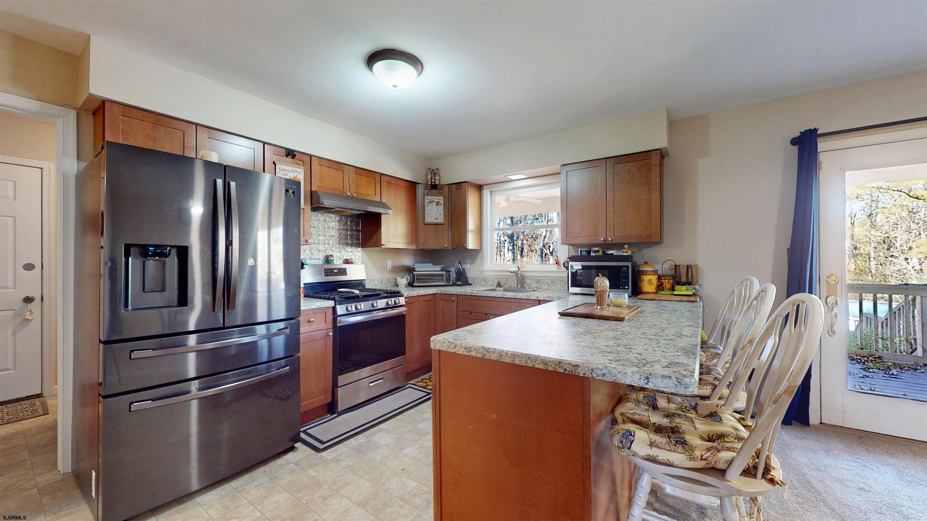 28 Luke Court Seaville, NJ 08230 - Photo 9 of 39 a kitchen with stainless steel appliances granite countertop a refrigerator stove and sink