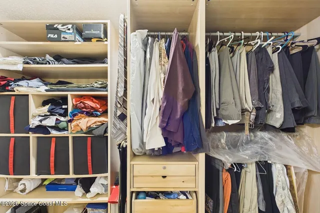 a bedroom with a bed and a large mirror