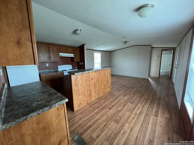 a view of a kitchen with wooden floor