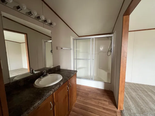 a bathroom with a granite countertop sink shower mirror and a sink