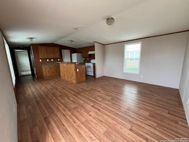a view of a livingroom with a furniture wooden floor and window