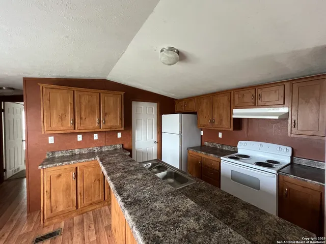 a kitchen with a stove and a refrigerator