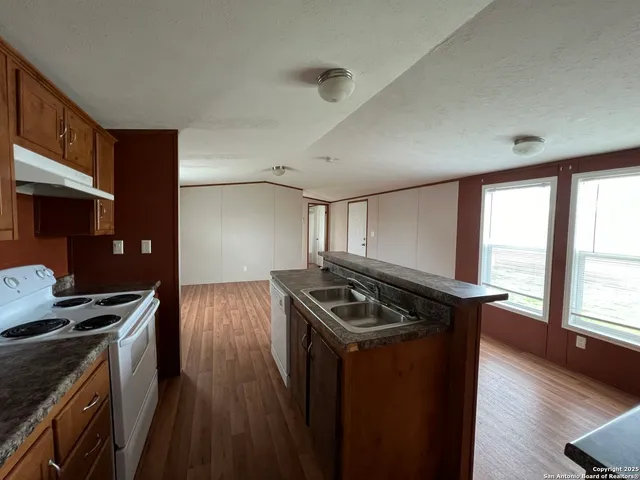 a kitchen that has a sink and a stove