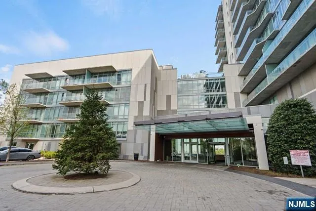 a front view of a building with a garden