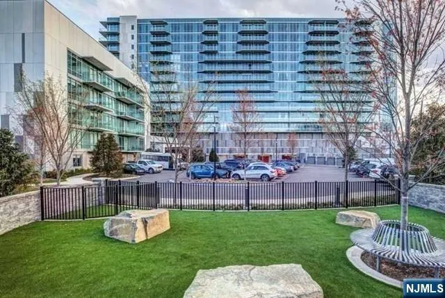 a front view of a building with garden and seating area