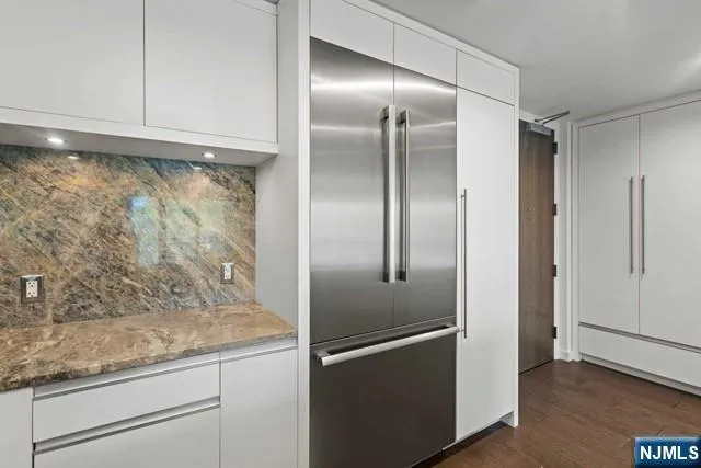 a view of a refrigerator in kitchen and wooden floor