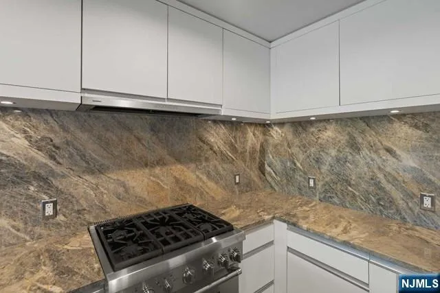 a kitchen with a stove and a stove