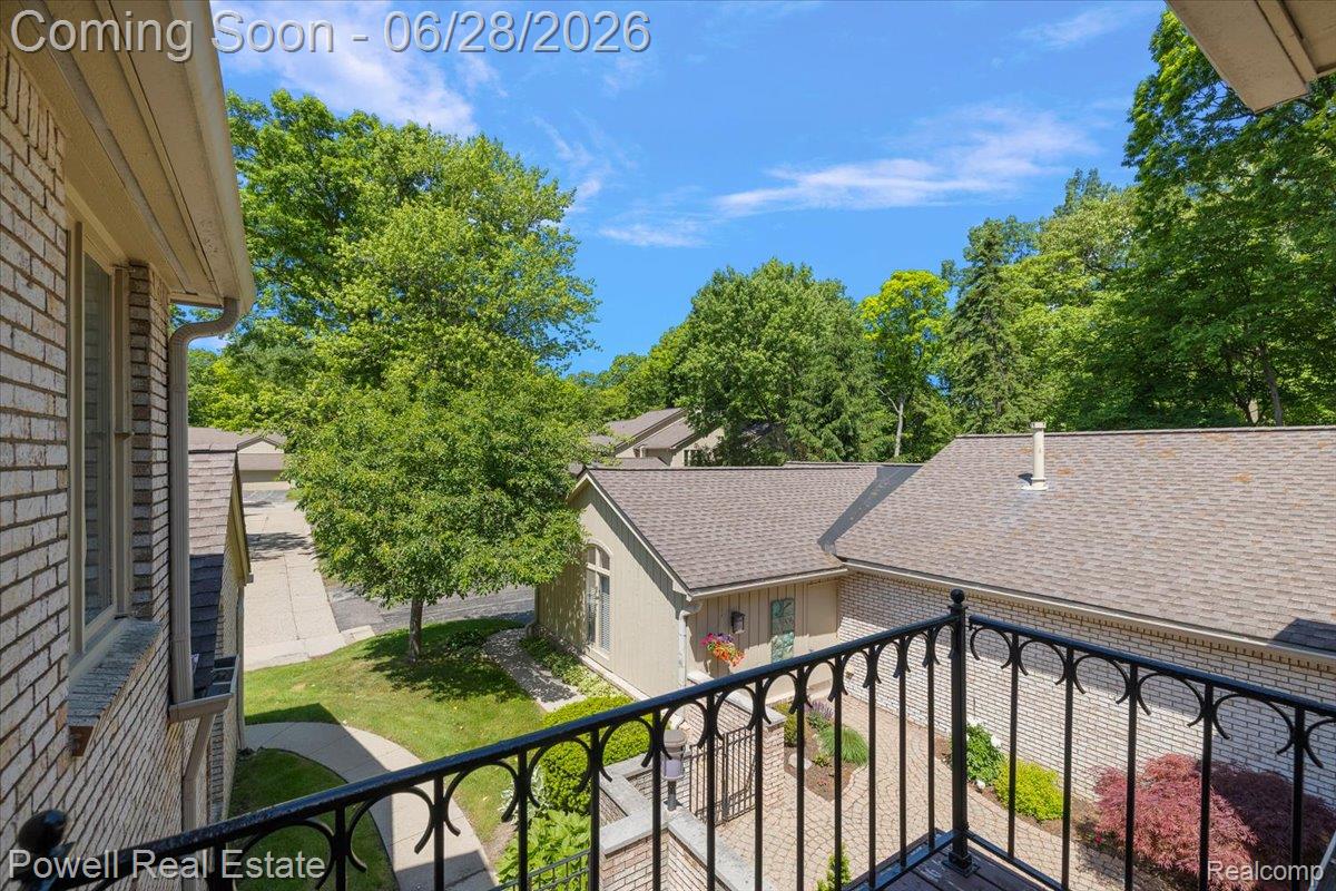 1447 Ravineview Court, Unit C12 Bloomfield Hills, MI 48304 - Photo 38 of 49 Balcony with decorative black wrought iron railing overlooking a paved courtyard