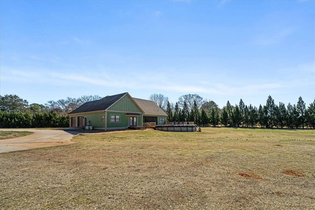 212 Winding Lane Seneca, SC 29672 - Photo 34 of 47 This expansive estate offers ample land, an inviting above-ground pool, and a charming home.