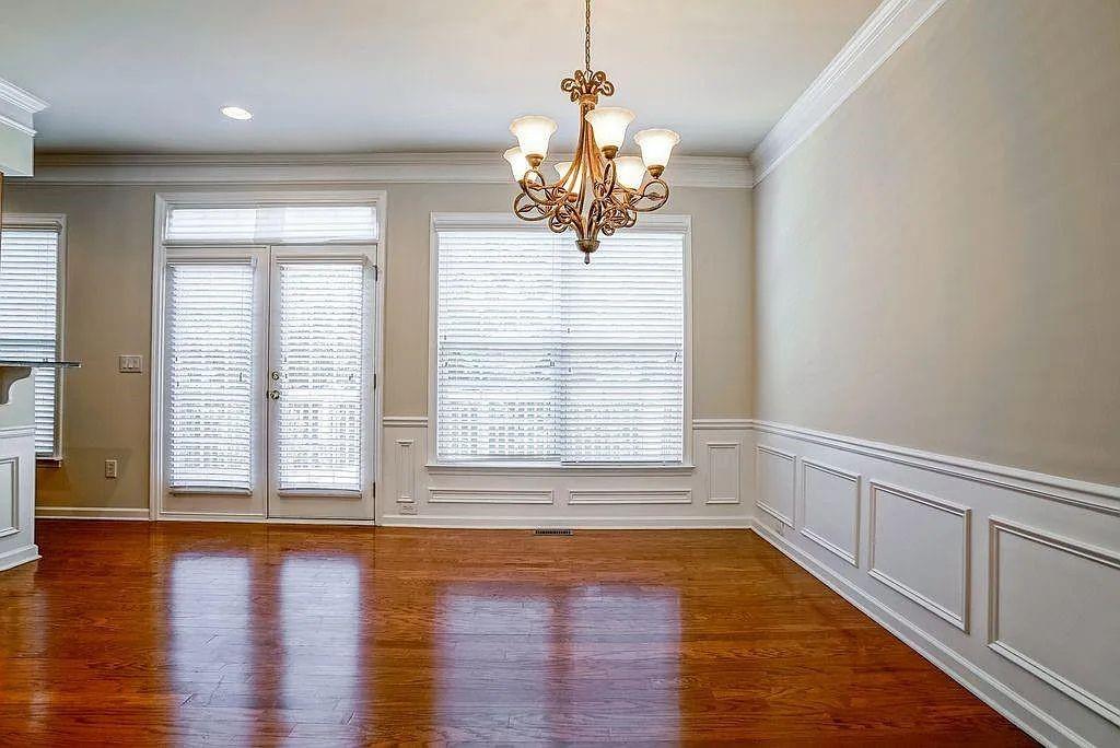 6120 Joybrook Road Duluth, GA 30097 - Photo 13 of 30 a view of an empty room with wooden floor and a window