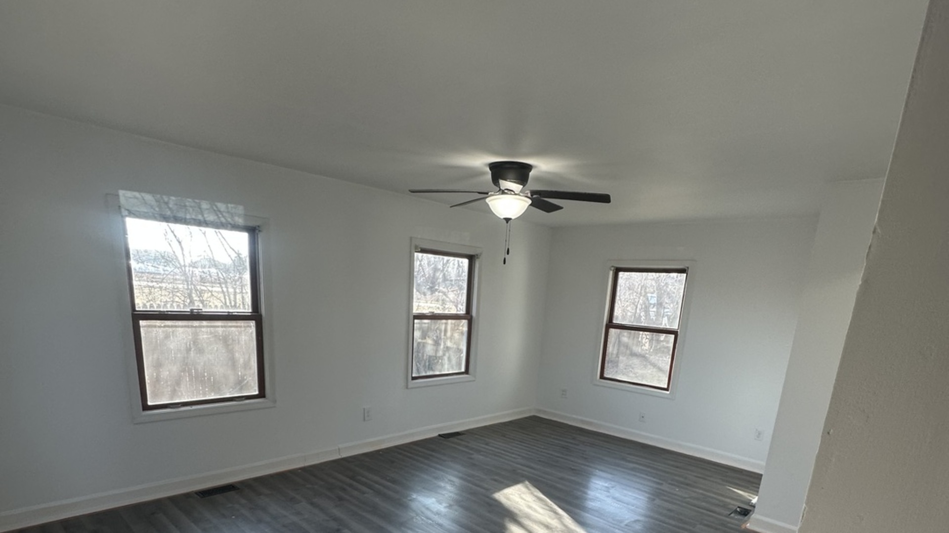 410 Ivanhoe Road Grayslake, IL 60030 - Photo 3 of 9 a view of an empty room with a window and wooden floor