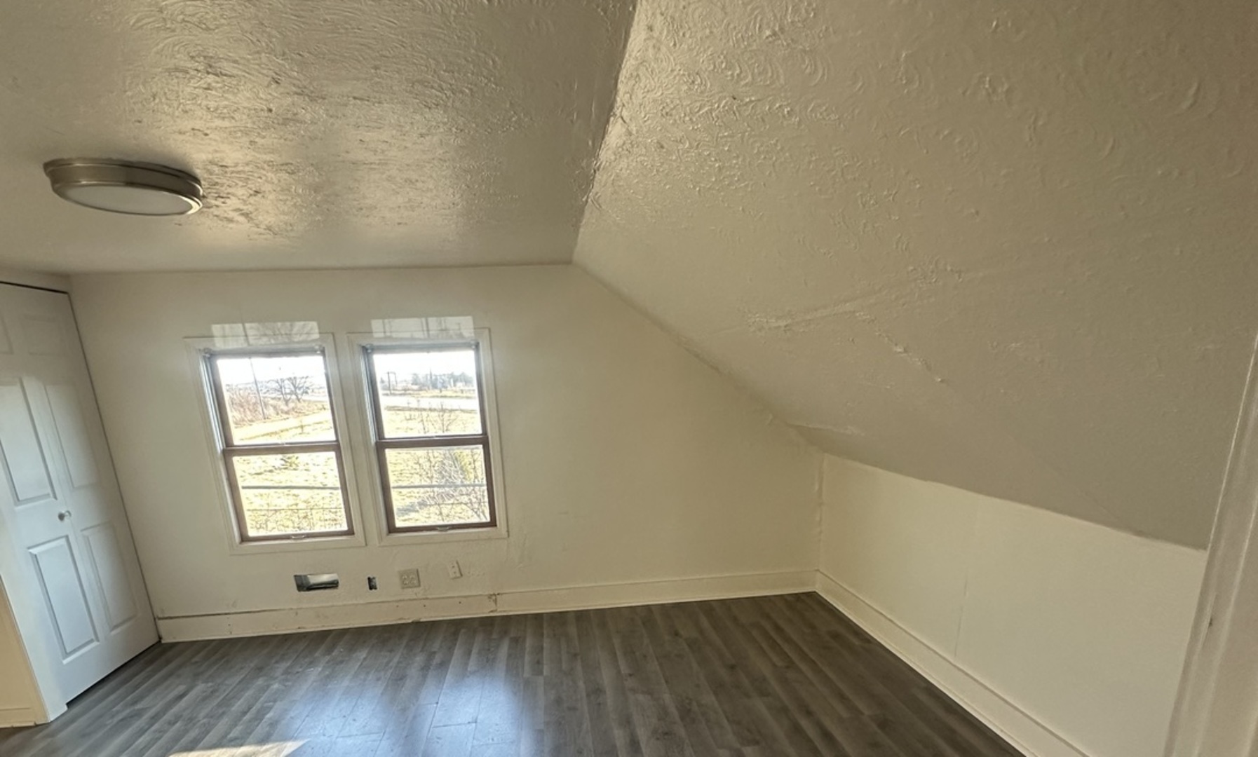 410 Ivanhoe Road Grayslake, IL 60030 - Photo 6 of 9 an empty room with wooden floor and windows