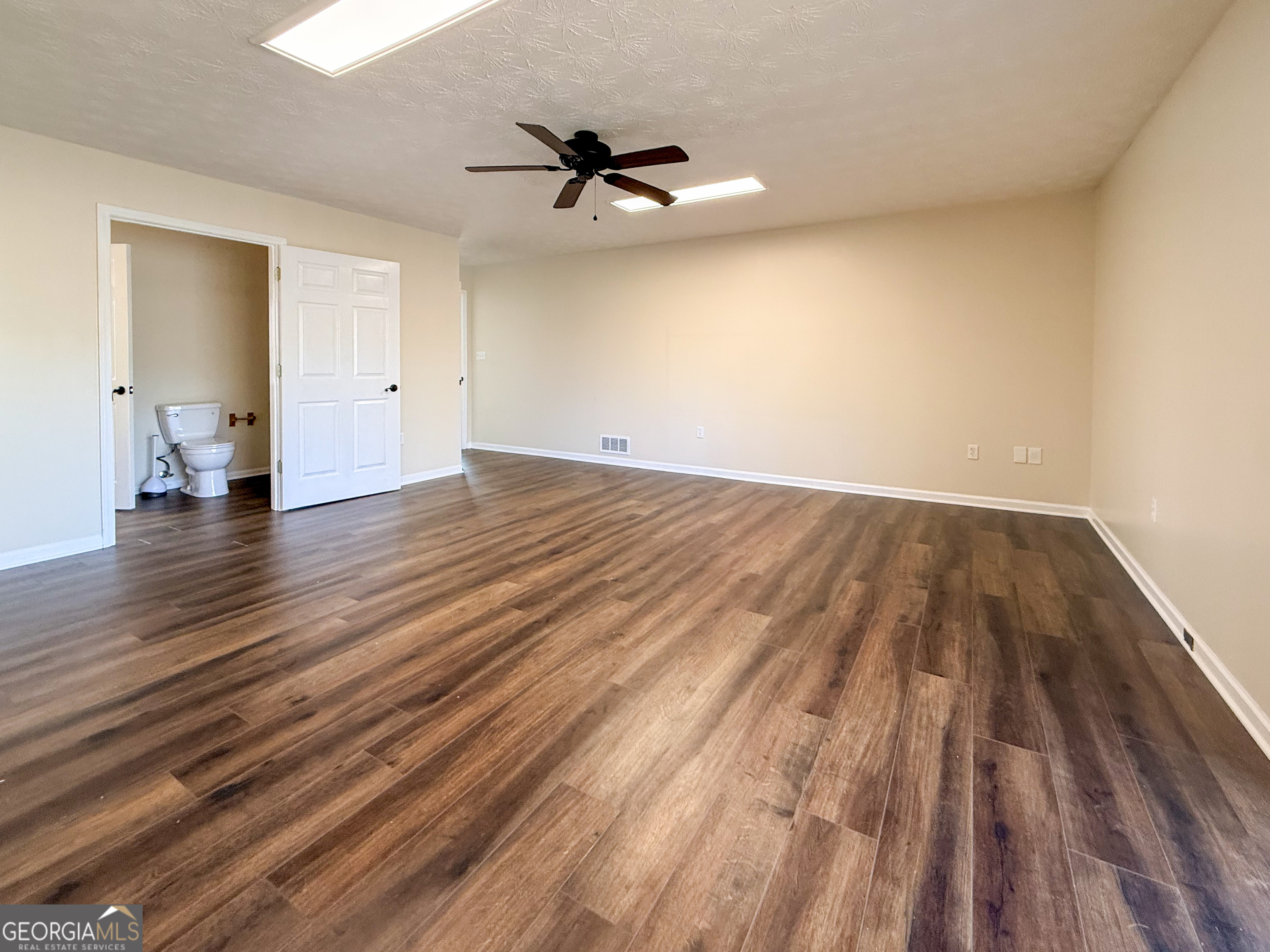 499 Old Deer Path Way Cleveland, GA 30528 - Photo 15 of 26 a view of empty room with wooden floor and fan