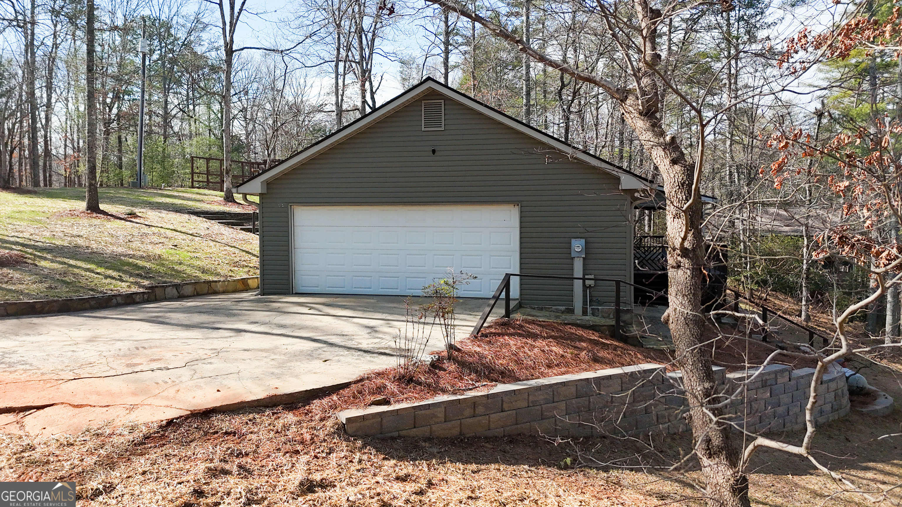 499 Old Deer Path Way Cleveland, GA 30528 - Photo 20 of 26 a backyard of a house with garage and trees