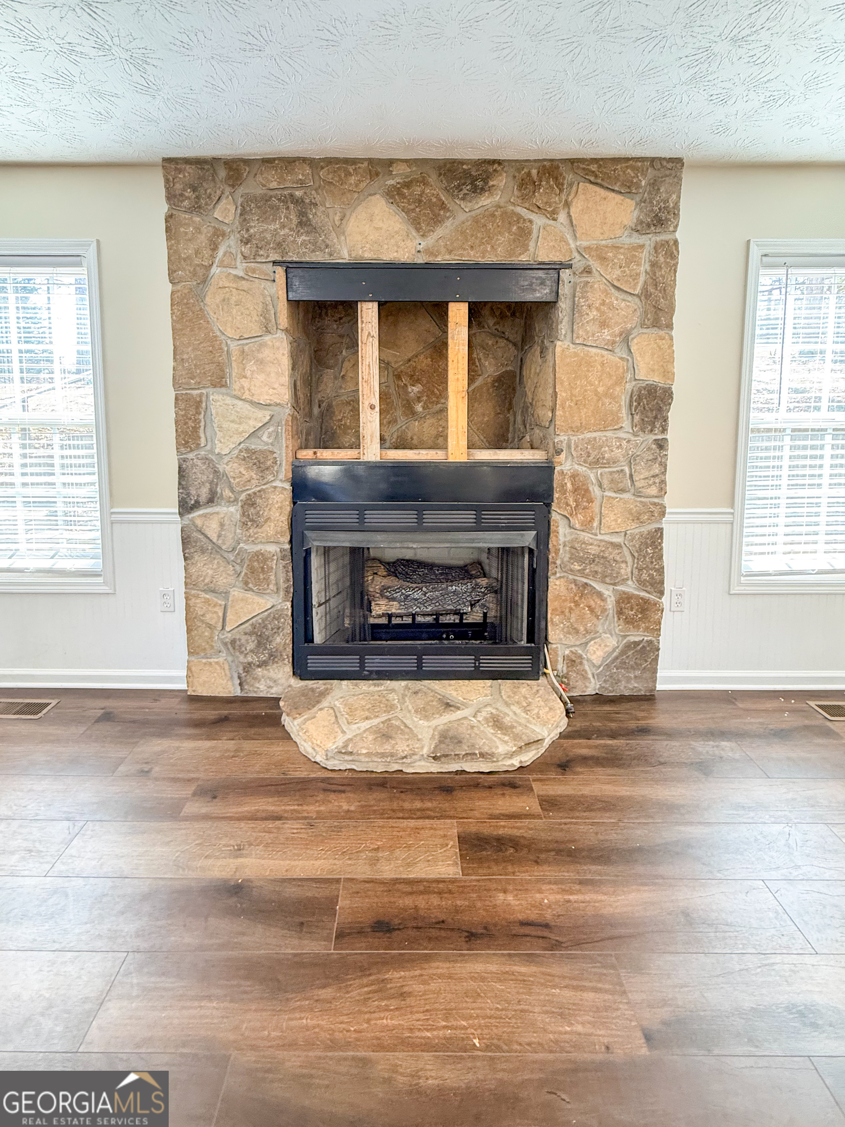 499 Old Deer Path Way Cleveland, GA 30528 - Photo 5 of 26 a living room with a fireplace and a table