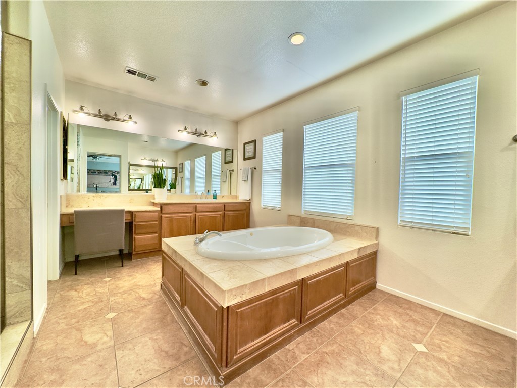 11265 Runyan Road Beaumont, CA 92223 - Photo 79 of 138 a spacious bathroom with a double vanity sink and a mirror