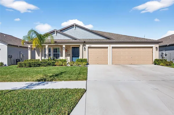 a front view of a house with a yard and garage