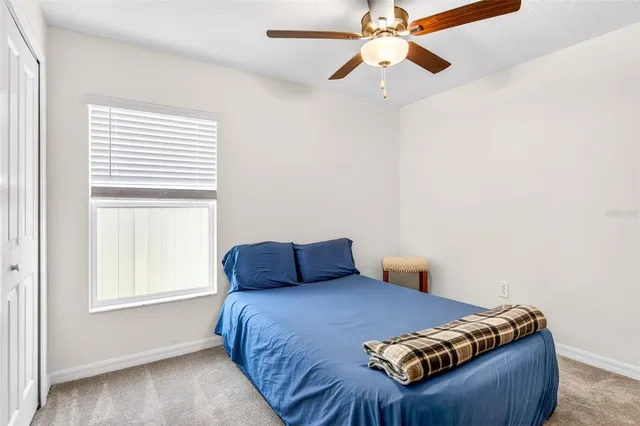 a bedroom with a bed and window