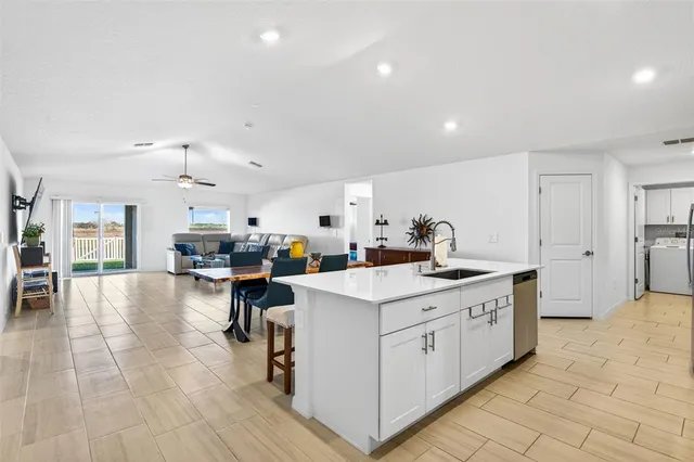 a kitchen with stainless steel appliances granite countertop a sink and a refrigerator