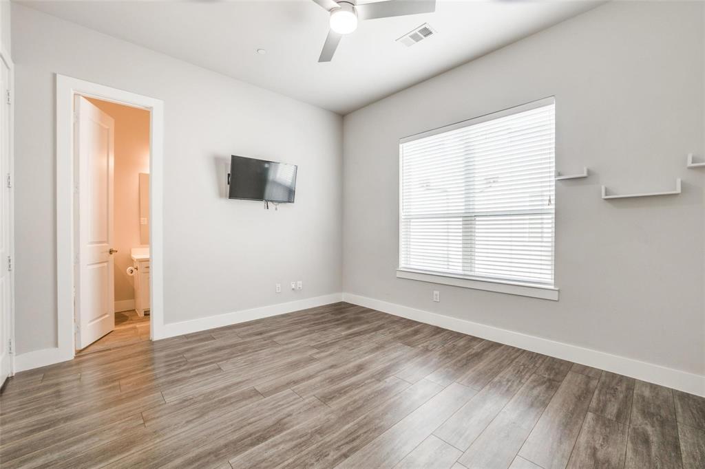 4785 Asher Place Dallas, TX 75204 - Photo 13 of 30 an empty room with wooden floor and windows