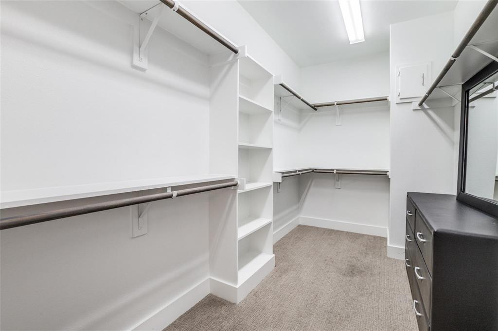 4785 Asher Place Dallas, TX 75204 - Photo 18 of 30 a view of walk in closet with empty racks
