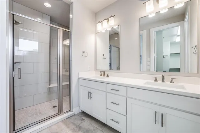 a bathroom with double sink and a mirror