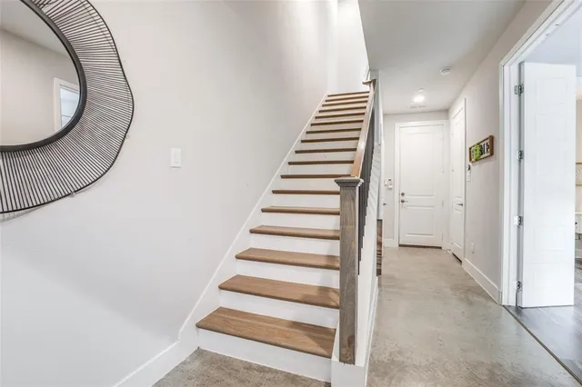 a view of a hallway with wooden floor and entryway