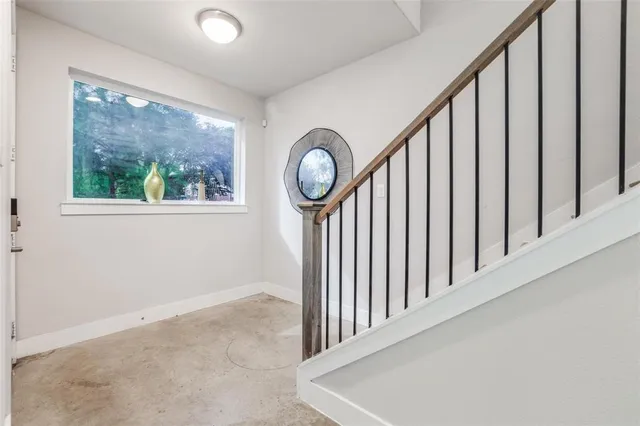 a view of a hallway with wooden floor and a front door