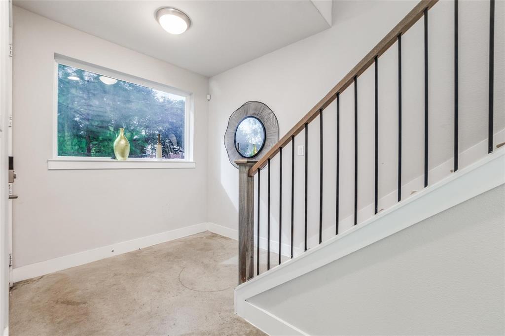 4785 Asher Place Dallas, TX 75204 - Photo 4 of 30 a view of a hallway with wooden floor and a front door