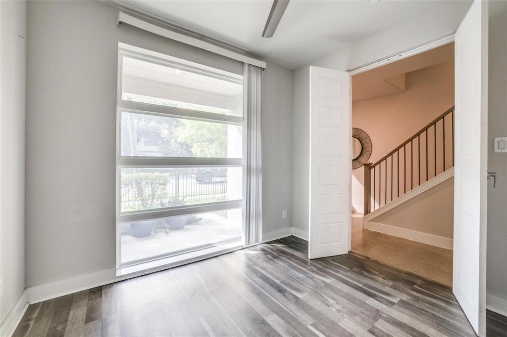 4785 Asher Place Dallas, TX 75204 - Photo 5 of 30 a view of an empty room with wooden floor and a window