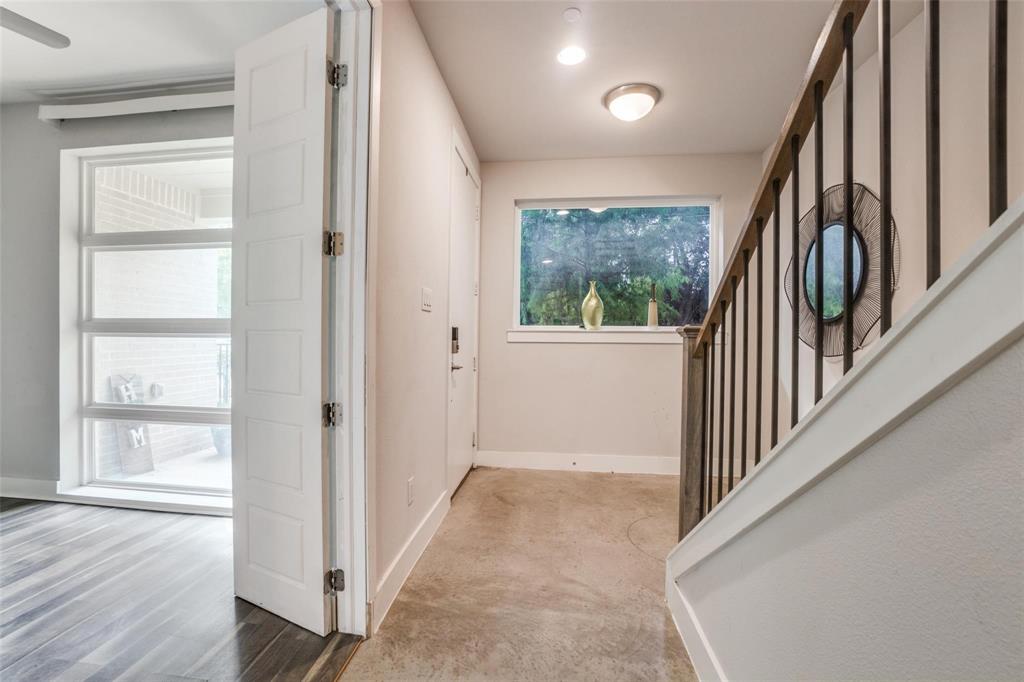4785 Asher Place Dallas, TX 75204 - Photo 6 of 30 a view of a hallway with wooden floor and stairs