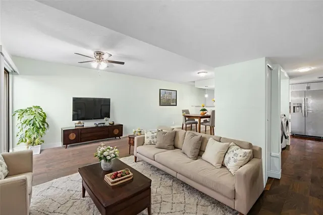 a view of a kitchen with wooden floor and electronic appliances