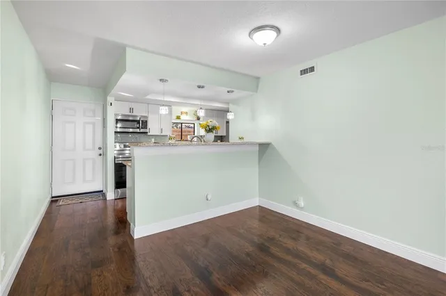 a spacious bathroom with a granite countertop sink a mirror and shower