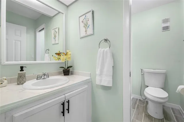 a white toilet sitting next to a bath tub