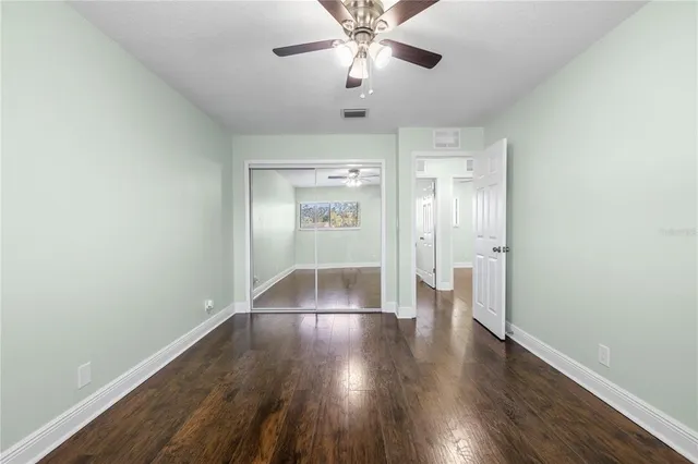a view of an empty room with wooden floor
