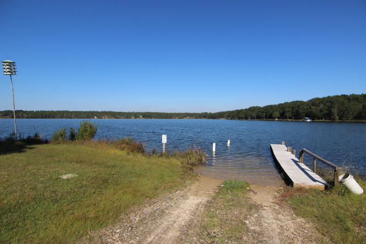 10 Spring Lake Road DeFuniak Springs, FL 32433 - Photo 11 of 14 a view of a lake with houses in the background