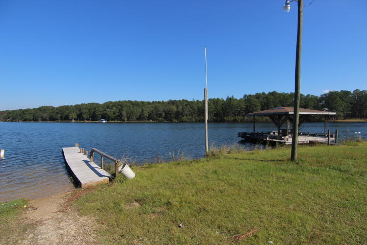 10 Spring Lake Road DeFuniak Springs, FL 32433 - Photo 12 of 14 a view of a lake with a sitting space