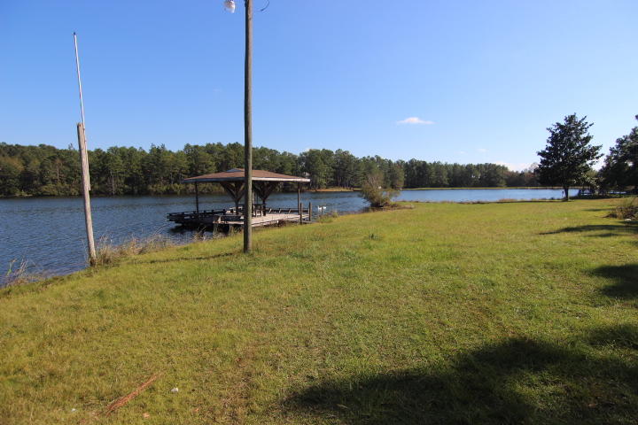 10 Spring Lake Road DeFuniak Springs, FL 32433 - Photo 13 of 14 a view of a lake with a house in background