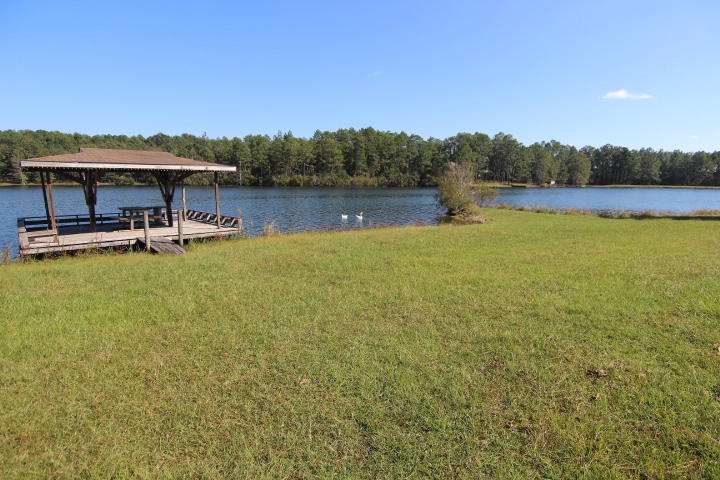 10 Spring Lake Road DeFuniak Springs, FL 32433 - Photo 14 of 14 a view of a lake with houses in the back