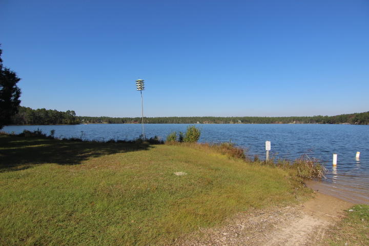 10 Spring Lake Road DeFuniak Springs, FL 32433 - Photo 10 of 14 a view of a lake with houses in the background